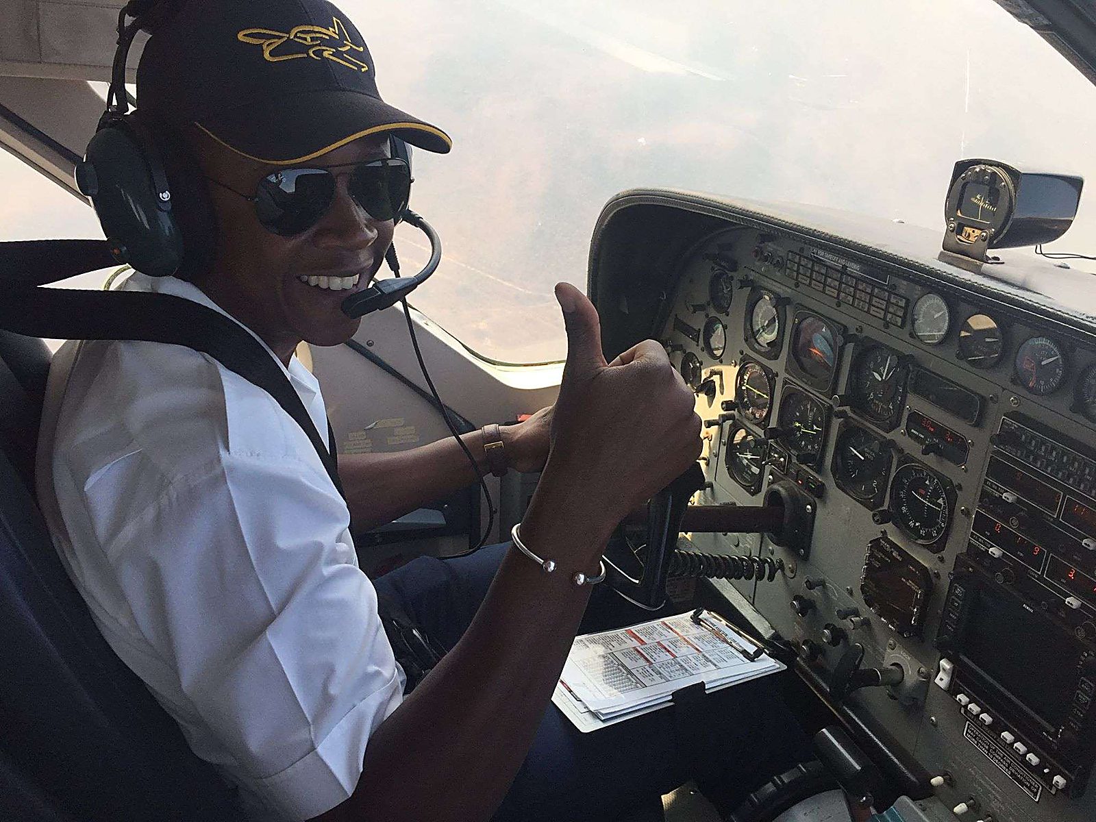 Student giving a thumbs up in the cockpit